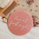 10cm Acrylic birth announcement in blush that reads "love at first sight".